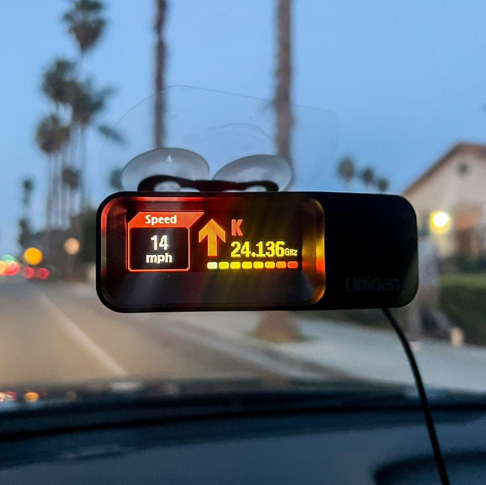 Radar detector on car dashboard